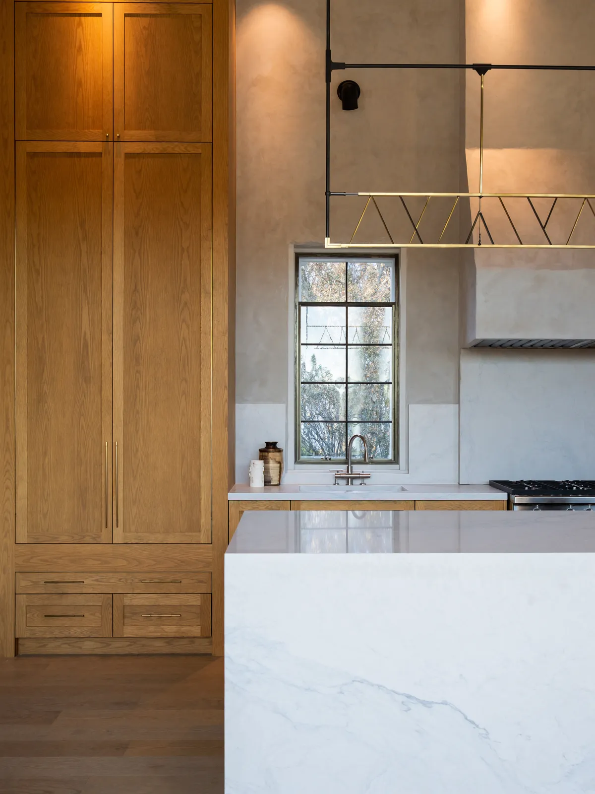 A finished custom kitchen with hand-built cabinetry and stone counters